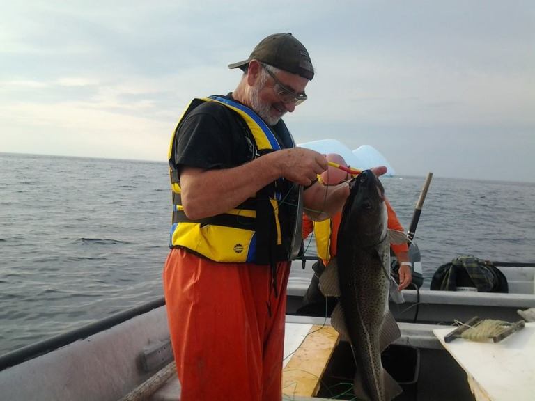 Gerald and his little friend with an iceberg background. Photo credit Leo Mckenna