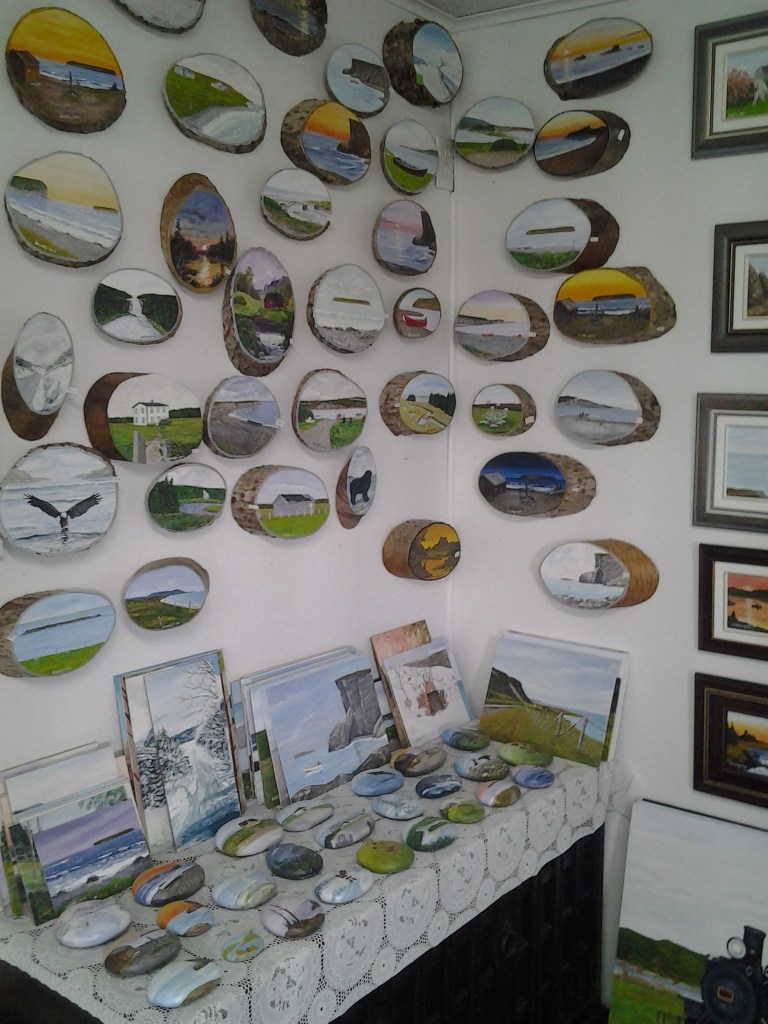 Wood slabs and beach rocks are painted allowing small, portable souvenirs of the Port au Port Peninsula at Island Studio Art Gallery, Mainland, Newfoundland