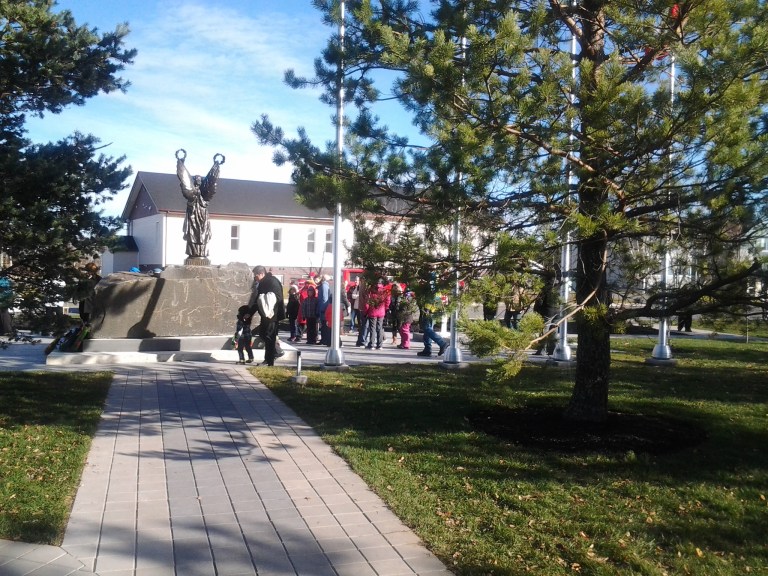 People after the ceremony admiring the new design of the Gander Memorial Heritage Park, Remembrance Day, Gander, 2014